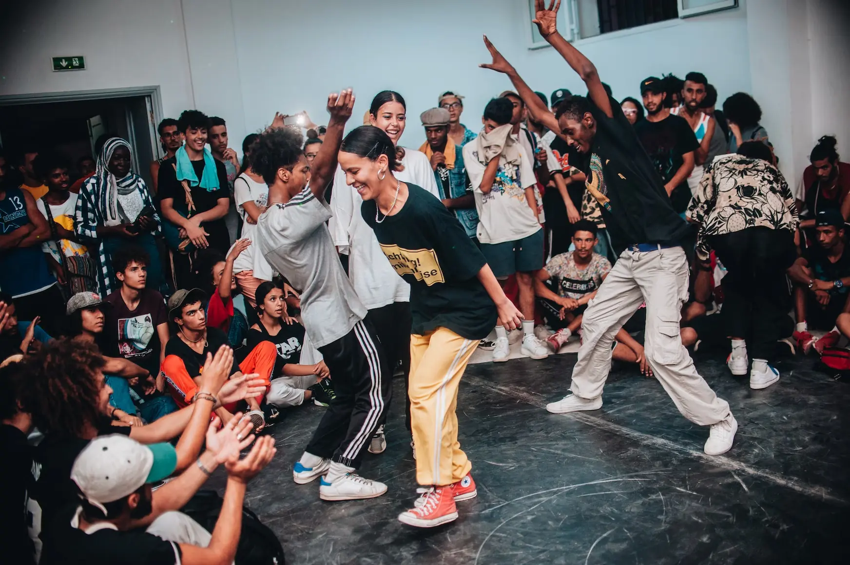A small group of people dancing in freestyle form.